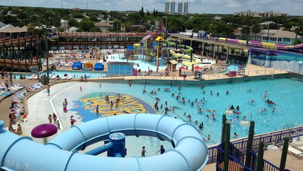 A water park with multiple pools, slides, and a large water slide.