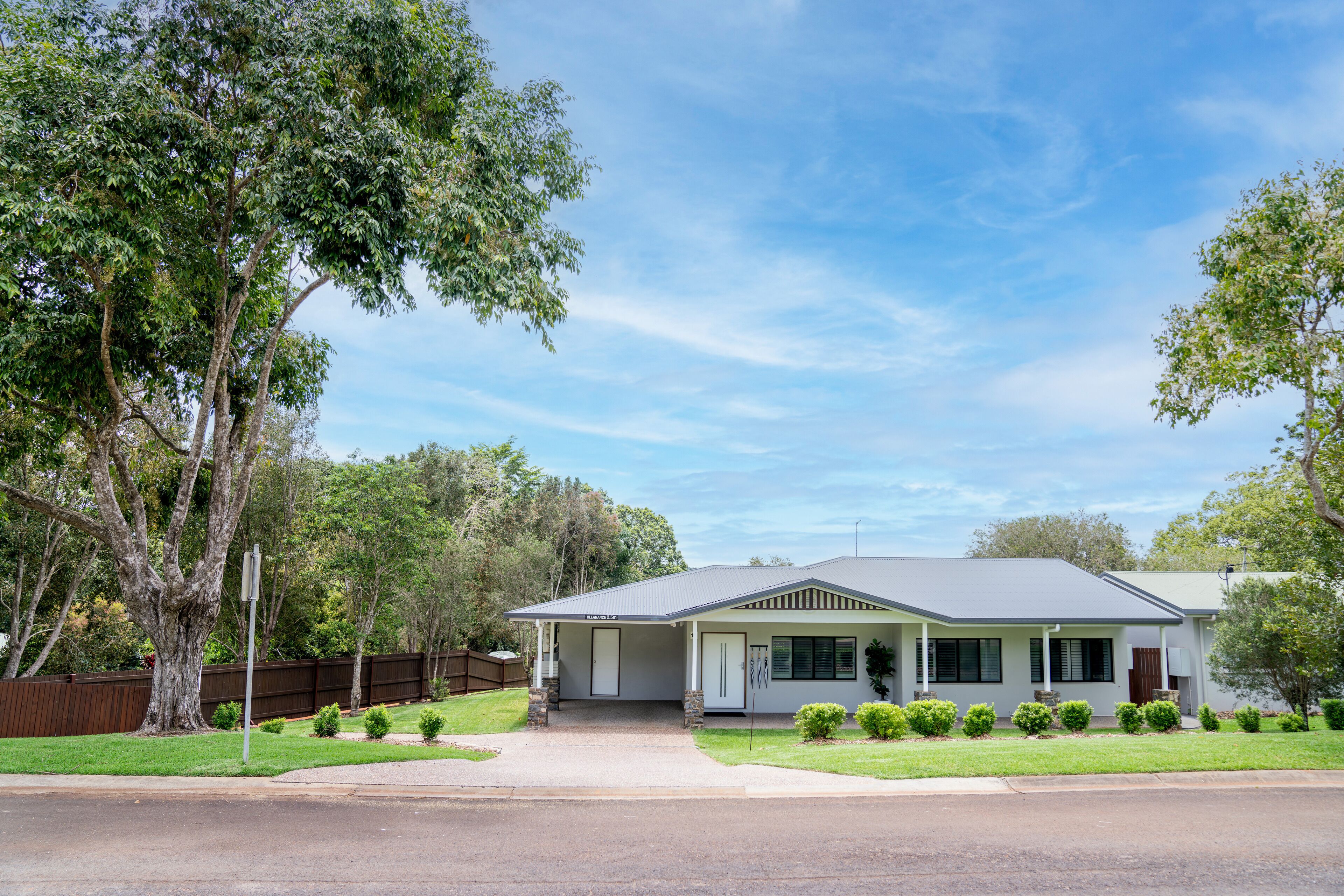 A single-story house with a front porch, a garage, and a well-maintained lawn.