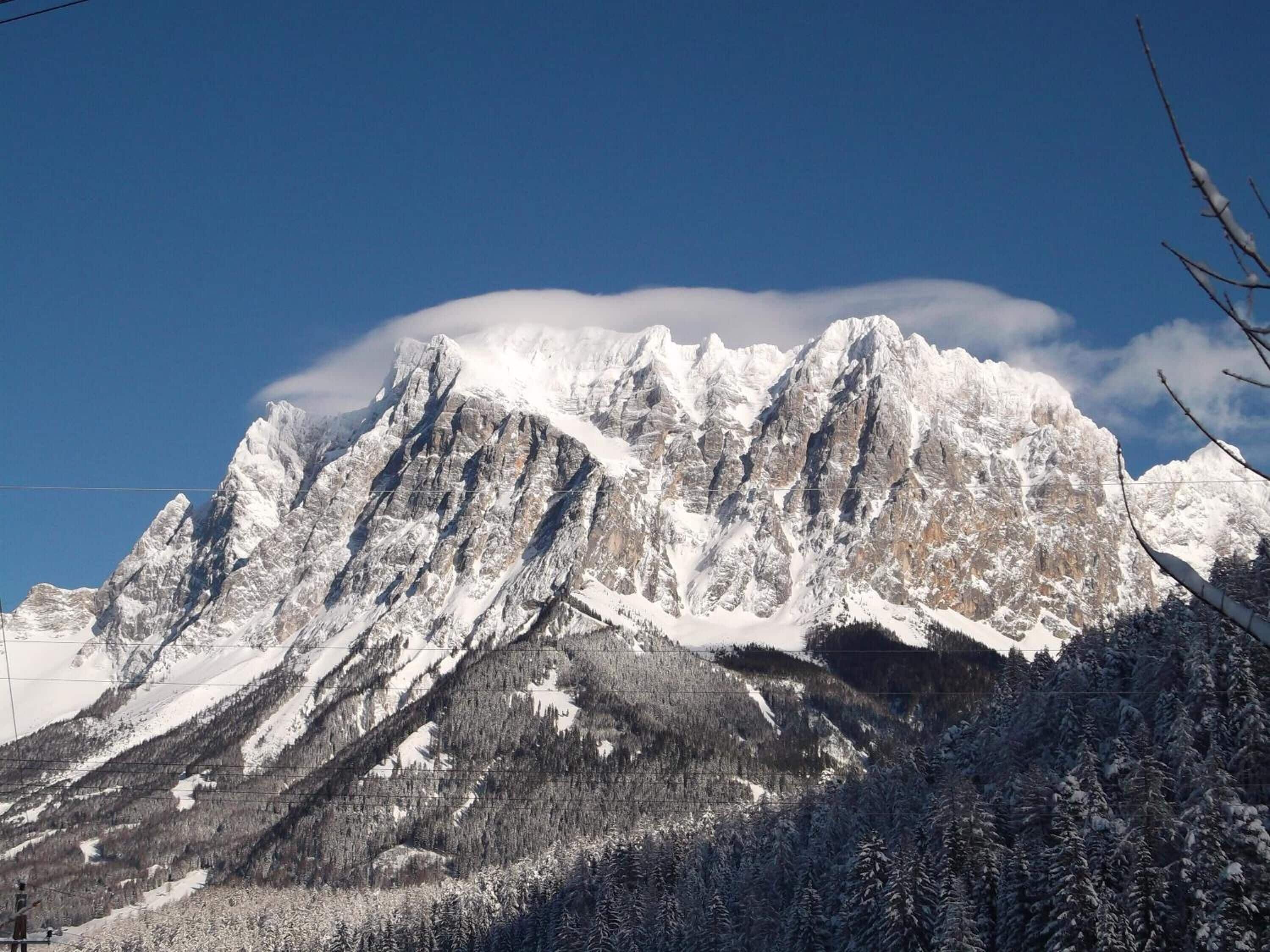 A snow-covered mountain range with a clear sky.