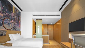 A modern hotel room with a large bed, a desk, a television, and a bathroom visible through a glass partition. - MiniMax Hotel Shanghai Songjiang (Shanghai)