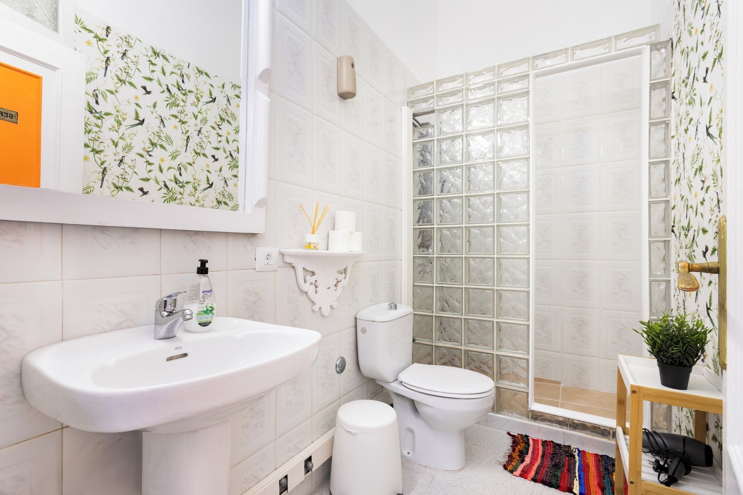 A bathroom with a sink, toilet, and shower.