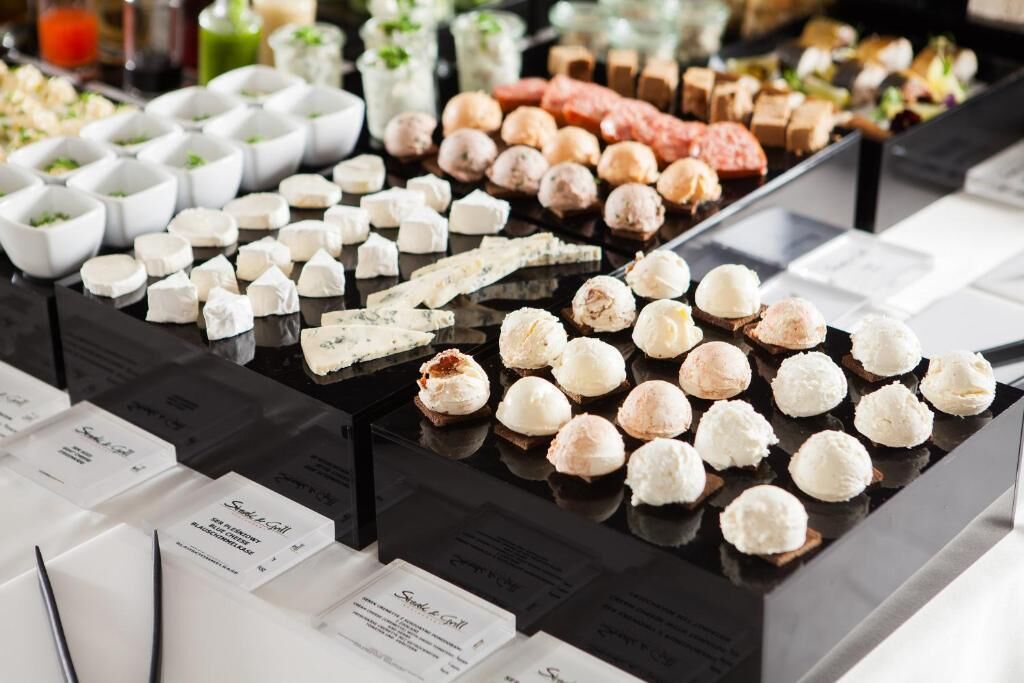 A variety of food items displayed on a counter with labels.