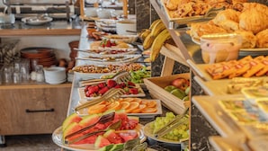 Un bufé con diversas opciones de comida, como frutas, verduras y pasteles.