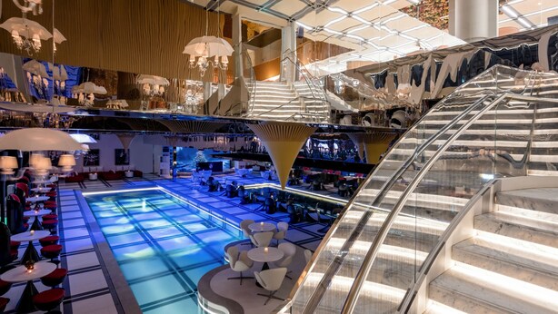 A modern interior with a central pool area, seating around the pool, and a glass staircase. - Novotel Suites Ambassador Seoul Yongsan - Seoul Dragon City (Seoul)