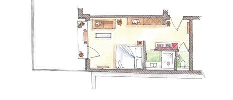 A floor plan of a room with a bed, a desk, a window, and a bathroom.
