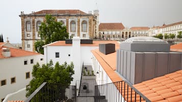 A view of a building with a tiled roof and a staircase leading to a balcony.