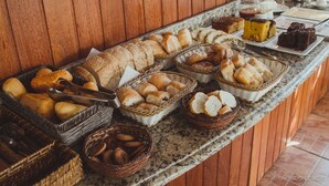 A buffet with various breads, pastries, and desserts. - Pousada Monteiro (Valenca)