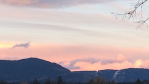 A mountainous landscape with a sunset.