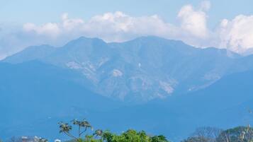 A mountainous landscape with a clear sky and some clouds.