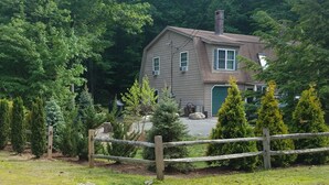 A house surrounded by a wooden fence and various trees. - Cozy and comfortable 3 bedroom.   (Alton)