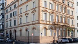 A multi-story building with a classic architectural style, featuring arched windows and a balcony on the upper floors. - Tuscany Viareggio exclusive beachfront apartment   (Viareggio)