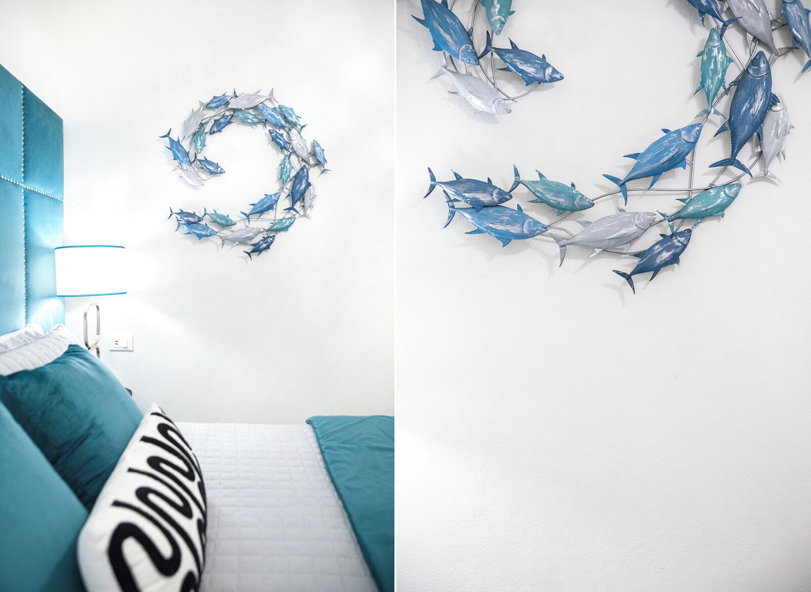 A bedroom with a bed, a bedside table, and a wall decoration of fish.