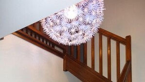 A wooden staircase with a white wall and three posters. - Chalet at the foot of the slopes and 5 minutes from shops and ski school (Vars)