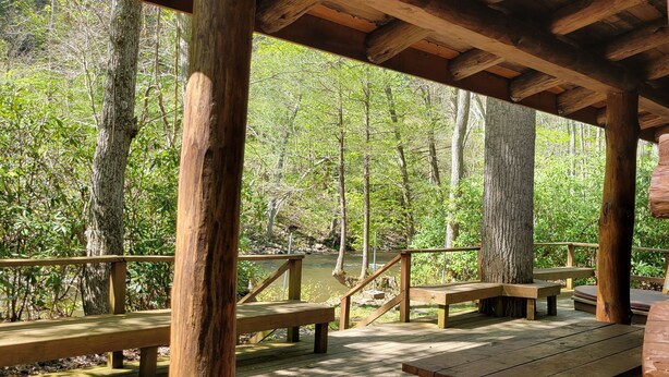 A wooden deck with benches overlooking a forested area. - Stay WATERFRONT !   Stay CHEAT RIVER LODGE (Elkins)