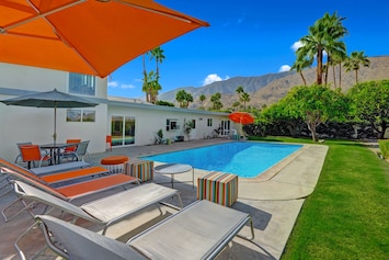 Dining table, chaise lounges and separate seating areas maximize the full yard.