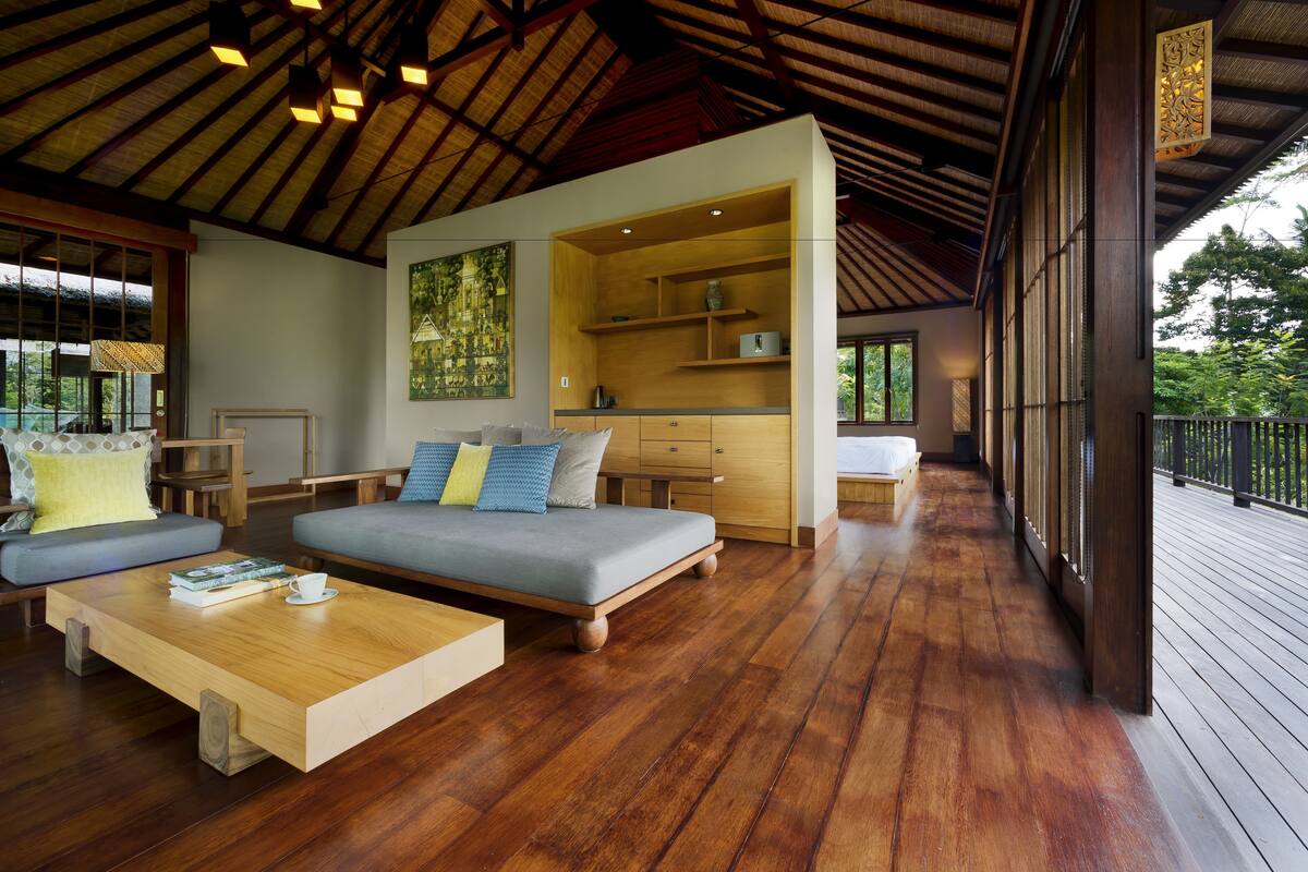 A spacious living area with a sofa, coffee table, and built-in shelving.