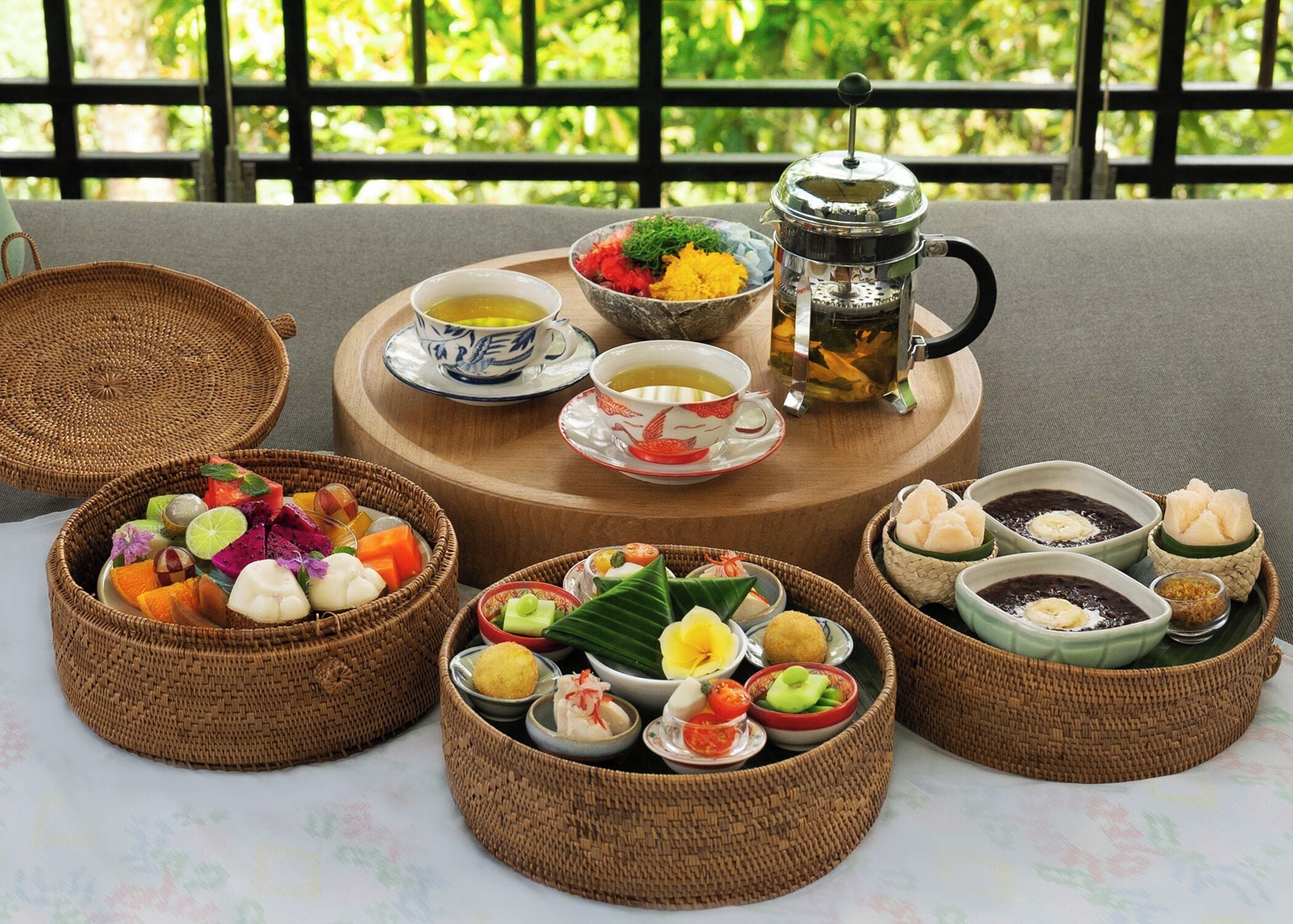 A table set with various dishes and a teapot, suggesting a dining experience.