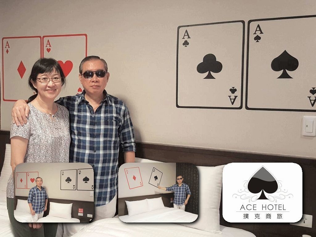 A hotel room with a bed, pillows, and a wall with playing cards.