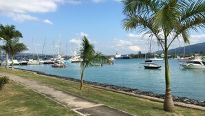 A marina with boats docked, a clear sky, and palm trees. - Anna's Joye Seawind - Studio Apt, Fully A/C close to beach, 24Hr Security. (Montego Bay)