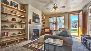 A cozy living room with a fireplace, wooden shelves, and a comfortable seating area. - Luxury condo, Walk to Theater & Restaurants, K & Q beds,  private gar. & grill (Park City)