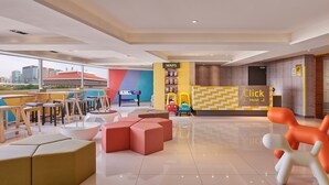 A modern hotel lobby with a 'Click Hotel' reception, seating areas, and a view of the cityscape. - Click Hotel - Taipei Main Station Branch (Taipei)