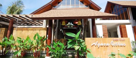 A hotel entrance with a sign reading "Ayara Villa."