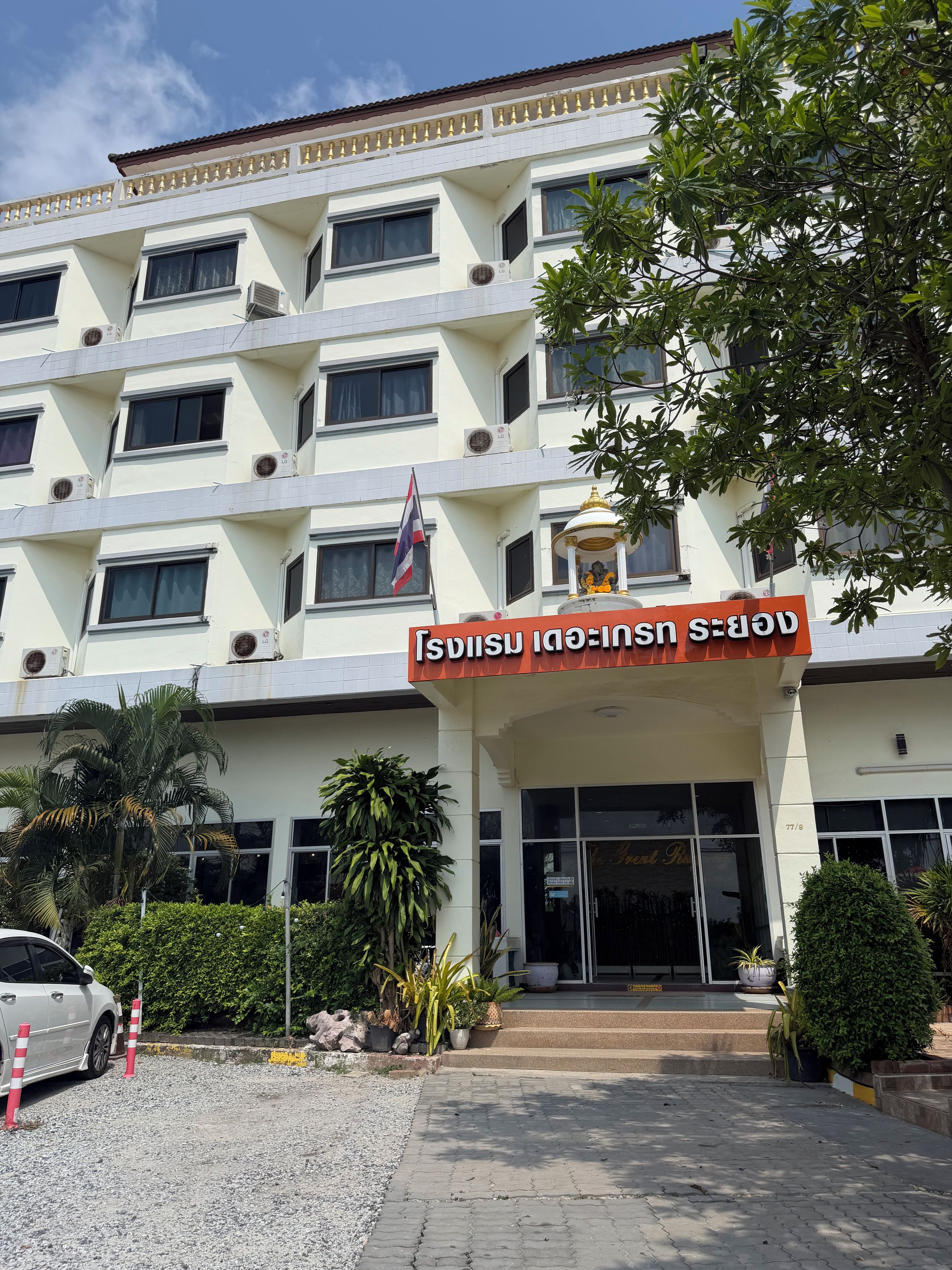 A multi-story building with a sign indicating it is a hotel.