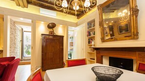 A dining area with a table, chairs, a fireplace, and a bookshelf. - Vatican luxury home Terrazzo, 2 bedrooms 2 bathrooms a 50 yds from  S.Pietro (Roma)