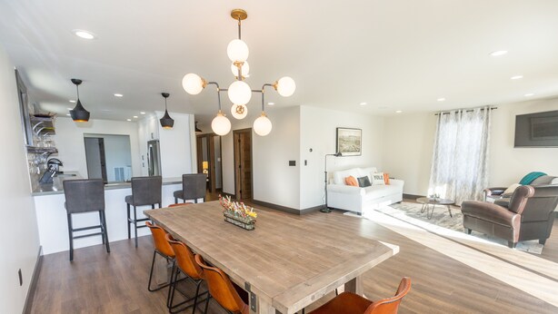 A modern kitchen with a wooden island, bar stools, and pendant lighting. - The Loft on Birch, Downtown Walla Walla, sleek modern industrial Condo (Walla Walla)