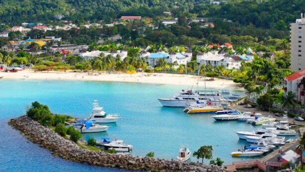 A coastal town with a marina, boats, and a beach. - Ocho Rios Modern Self Contained Studio with pool, cable, LED TV, fast Internet. (Ocho Rios)