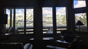A room with large windows offering a view of snow-covered hills and buildings. - New Remodeled interior plus outside updated in Upper DV walk to Silver Lake (DEER VALLEY)