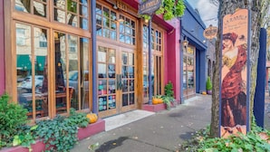 A restaurant with large windows, a red awning, and a sign reading "LA RAMBLA". - Incredible Luxury Loft in Historic Downtown McMinnville (McMinnville)