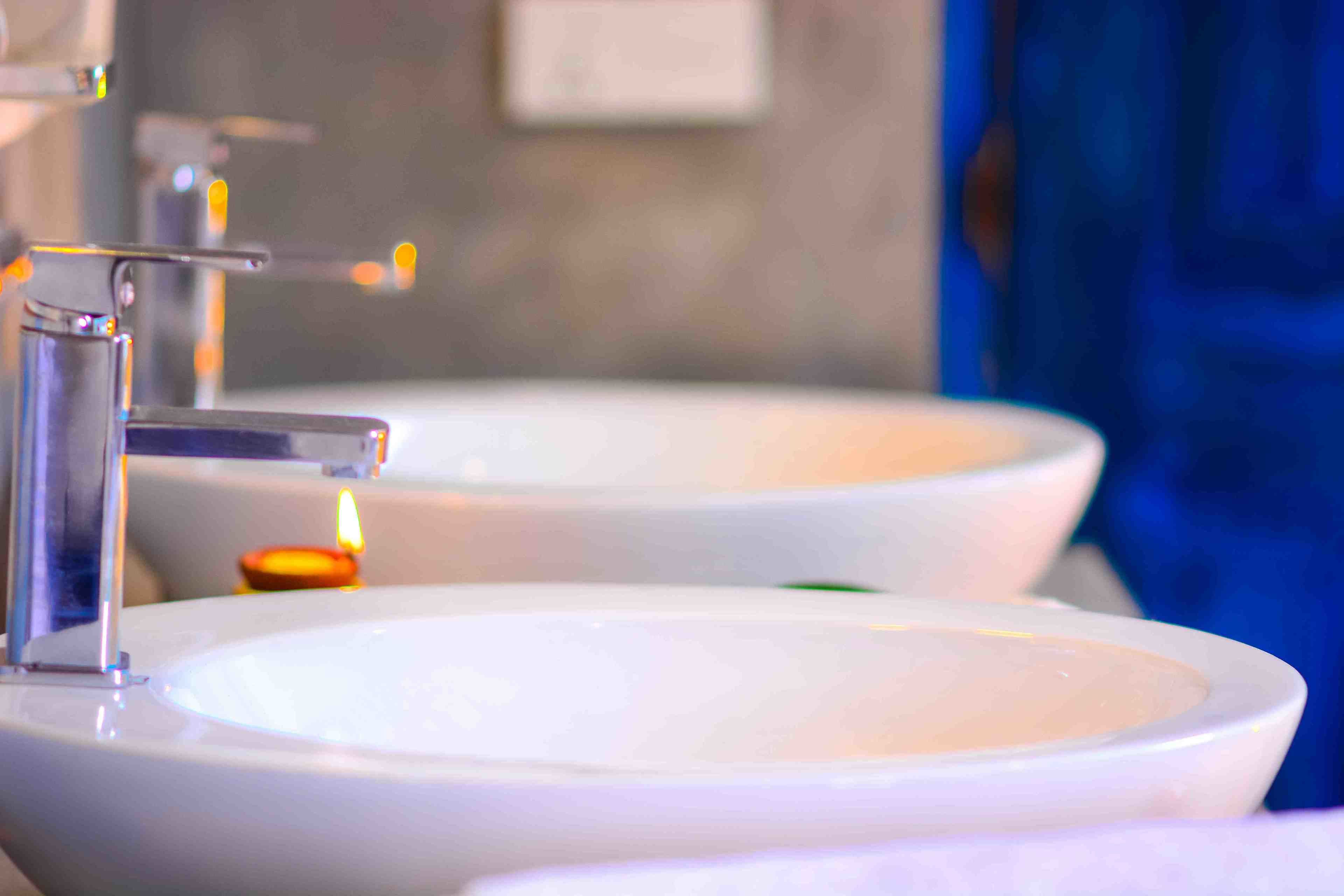 A bathroom with two sinks and a faucet.