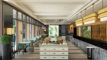 A modern hotel lobby with a long reception desk, seating area, and large windows.