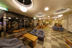 A hotel lobby with checkered flooring, leather seating, and circular ceiling lights. - Shokyoto No Yu Mikuma Hotel (Hita)