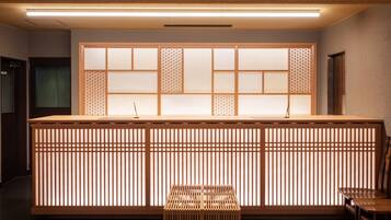 A reception desk with a traditional Japanese design, featuring sliding doors and a wooden counter.