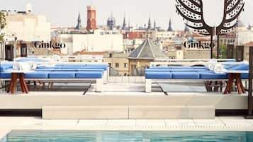 En säsongsöppen utomhuspool, solstolar och livvakter på plats