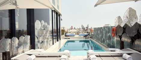 Seasonal outdoor pool, open 11:00 AM to 7:00 PM, sun loungers