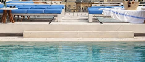 Seasonal outdoor pool, open 11:00 AM to 7:00 PM, pool loungers