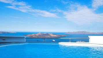 Una piscina al aire libre, sombrillas, tumbonas