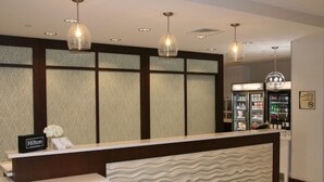 A hotel reception area with a modern design, including a reception desk, a minibar, and a chandelier. - Homewood Suites by Hilton Allentown Bethlehem Center Valley (Center Valley)