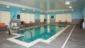 An indoor swimming pool with clear water, surrounded by chairs and a lifeguard chair. - Homewood Suites by Hilton Allentown Bethlehem Center Valley (Center Valley)