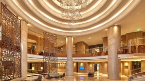 A spacious lobby with a central chandelier, multiple seating areas, and a polished floor. - Conrad Bengaluru (Bengaluru)