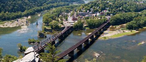 A bridge over a river with a town in the background.