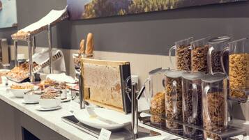 A buffet with various food items and utensils.