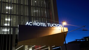 The exterior of the AC Hotel Tucson with a prominent illuminated sign. - AC Hotel by Marriott Tucson Downtown (Tucson)