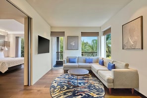 A modern living room with a sofa, coffee table, and artwork on the walls.