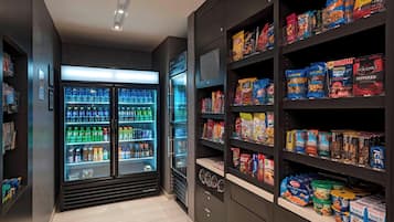 A grocery store with refrigerated sections and shelves stocked with snacks and beverages.
