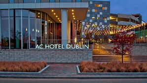The exterior of the AC Hotel Dublin with a modern design, large windows, and a well-lit entrance. - AC Hotel by Marriott Columbus Dublin (Dublin)