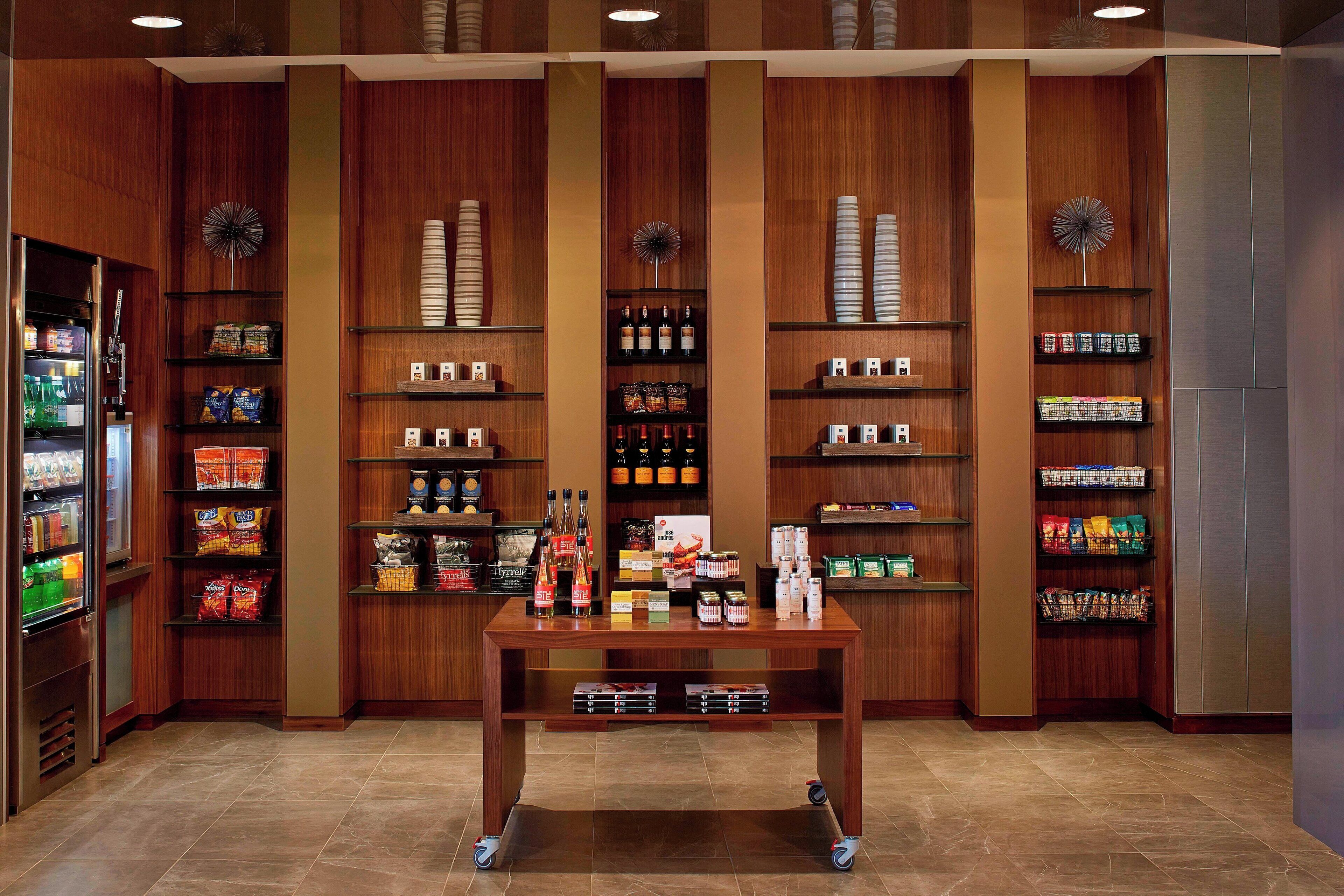 A well-organized retail space with shelves stocked with snacks, beverages, and other items.